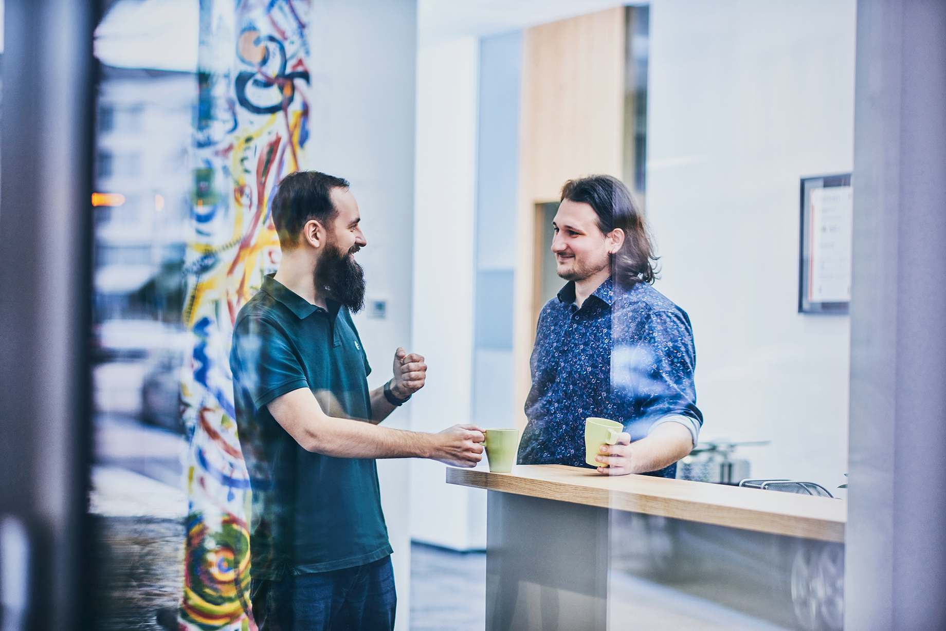 The two CEO's from the company s2G.at are standing on a bar while drinking coffee 